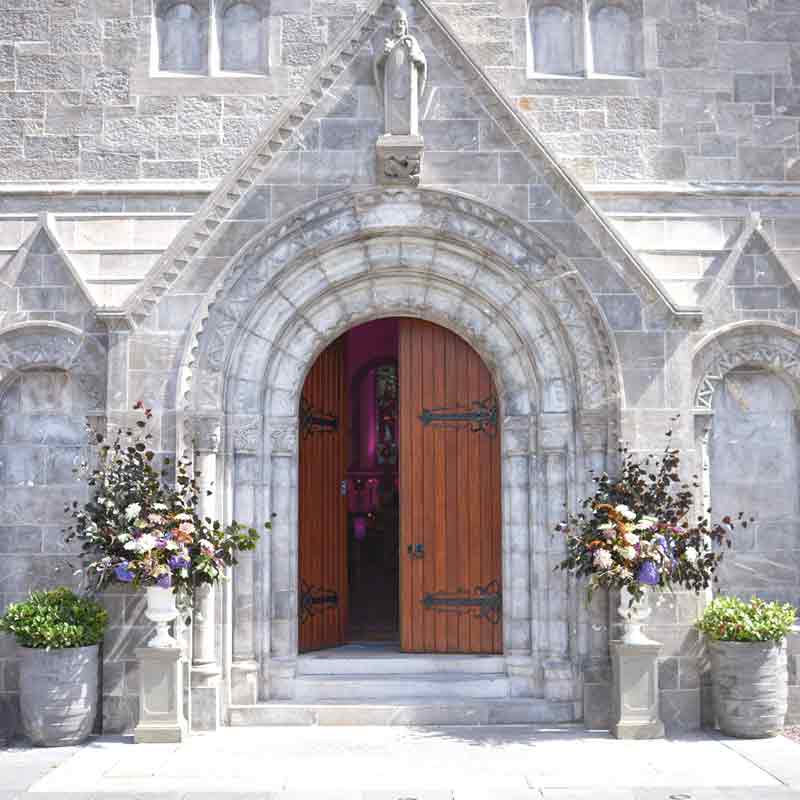 Wedding bouquets outside Honan chapel in UCC. One side of the door is open
